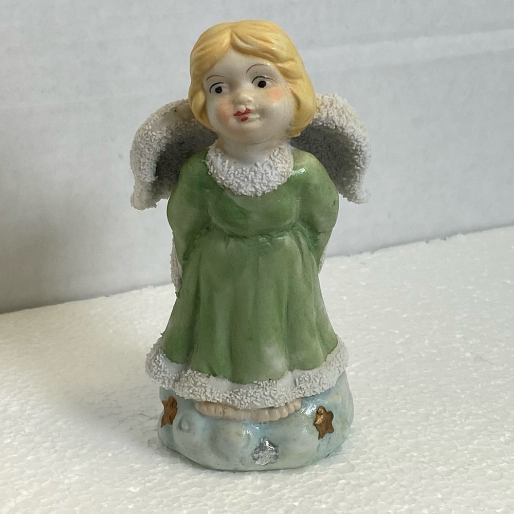 Vintage angle standing on cloud with starts  holding gold pot